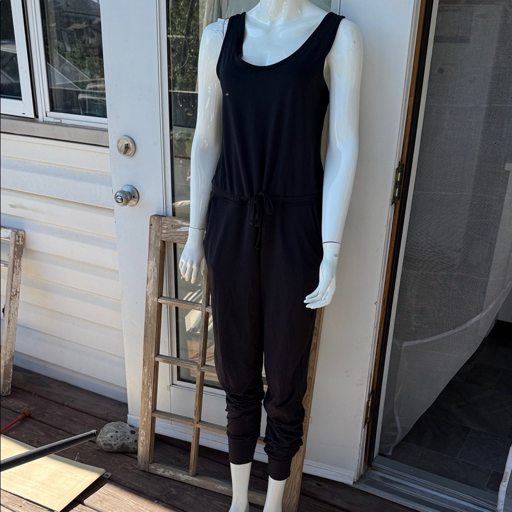 Joe fresh medium active wear romper with crisscross back black and pockets to!